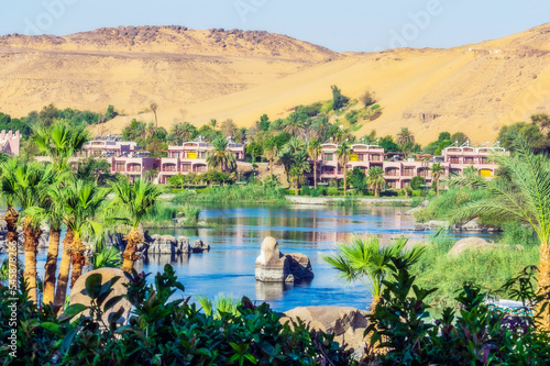 Egypt, Aswan Governorate, Aswan, City on bank on Nile river in summer photo