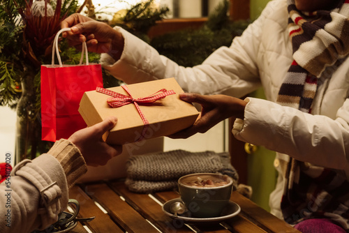 Women exchanging gifts with each other on Christmas photo