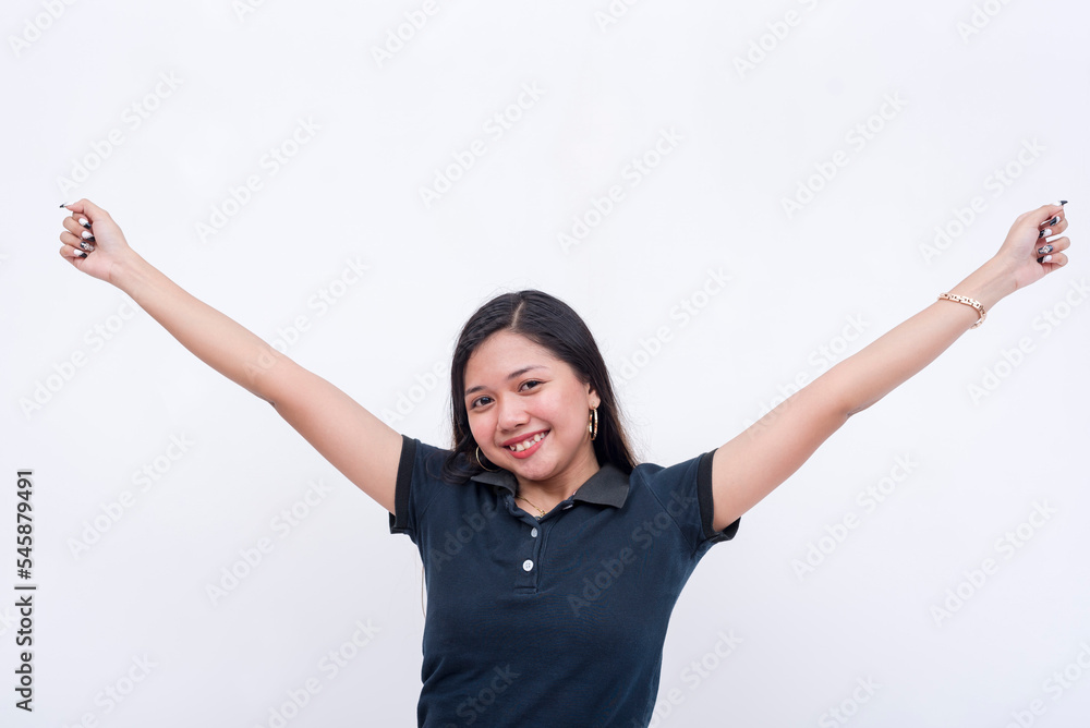 An excited young woman with outstretched arms, feeling happy and confident. Isolated on a white backdrop.
