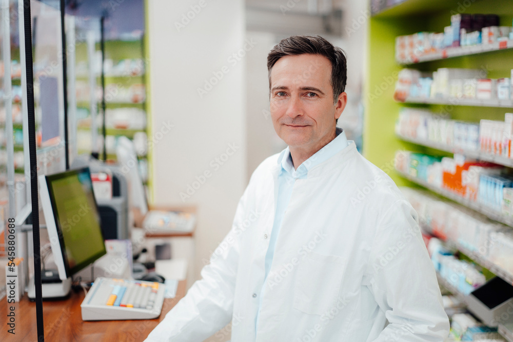 Smiling mature pharmacist in pharmacy Smiling mature pharmacist in pharmacy