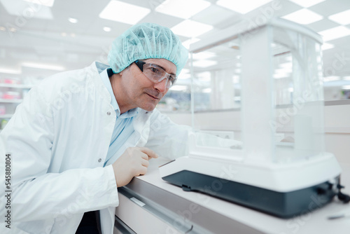 Chemist wearing protective eyewear experimenting in laboratory