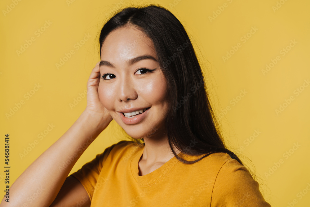Young asian woman wearing t-shirt smiling while looking at camera Young asian woman wearing t-shirt smiling while looking at camera