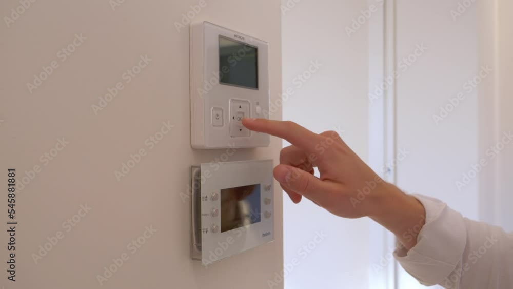 Hand changing the house temperature. Hand changing the house temperature.