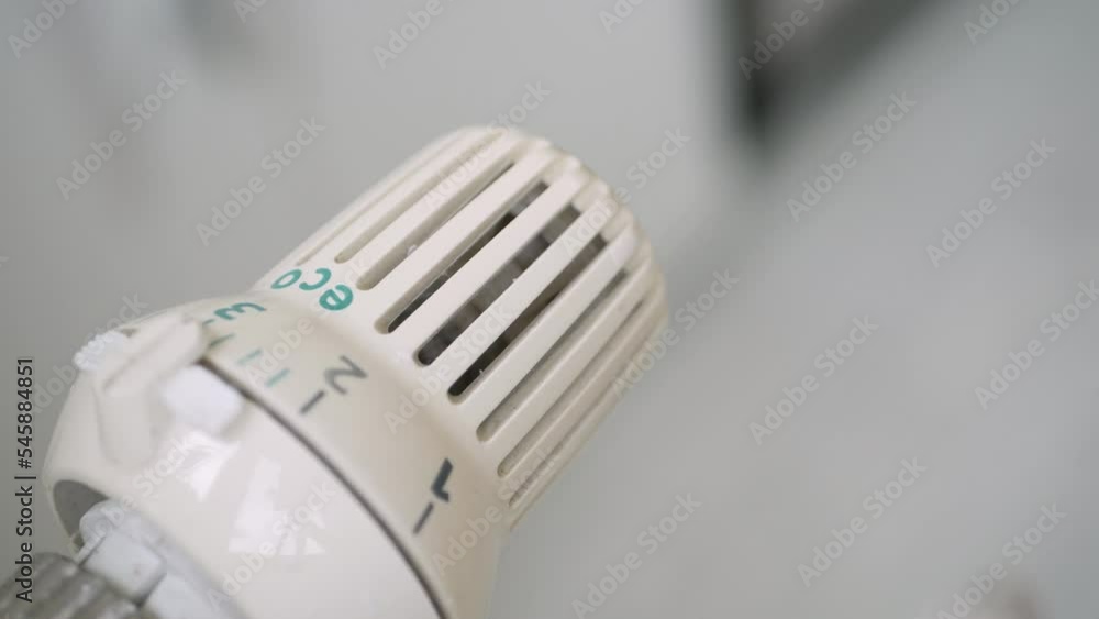 Setting High the Radiator Temperature, Changing Thermostat Value, and Checking Thermic Energy Consumption. Energy Crisis Concept. Setting High the Radiator Temperature, Changing Thermostat Value, and Checking Thermic Energy Consumption. Energy Crisis Concept.