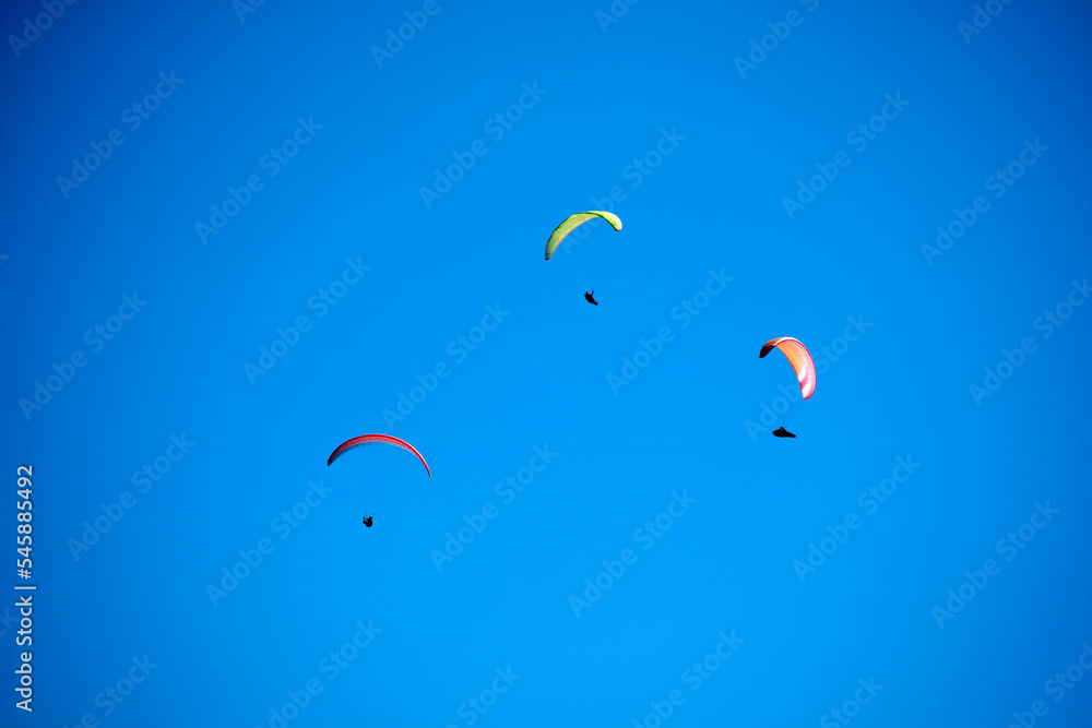 Photo shoot of the flight of a paragliding group Photo shoot of the flight of a paragliding group