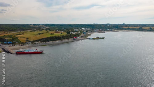 Aerial Timelapse showing ships in the Chacao Channel, bright blue sky day looking over Chiloe Island.
 photo