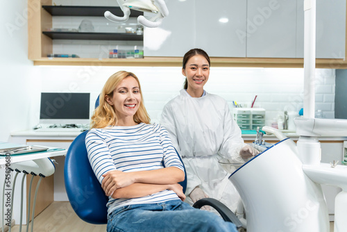 Portrait of Caucasian woman patient and dentist at health care clinic. 