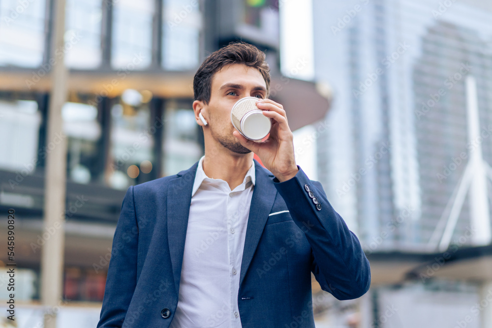 Caucasian young businessman talk on smartphone while walk in the city. Caucasian young businessman talk on smartphone while walk in the city.