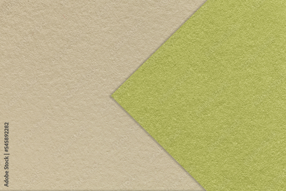Fototapeta premium Texture of craft beige paper background, half two colors with green arrow, macro. Kraft olive cardboard.