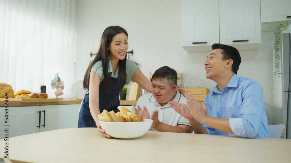 Asian happy family, mature parents baking bakery with son in kitchen. Asian happy family, mature parents baking bakery with son in kitchen.
