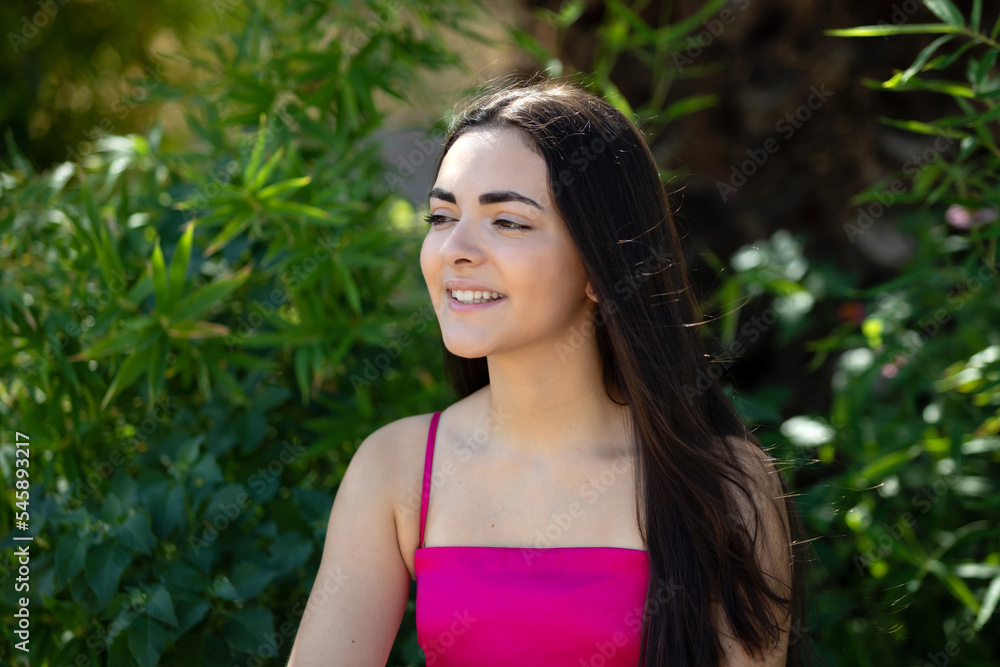 Portrait of a happy lovely and beautiful Spanish young woman in a park. Portrait of a happy lovely and beautiful Spanish young woman in a park.