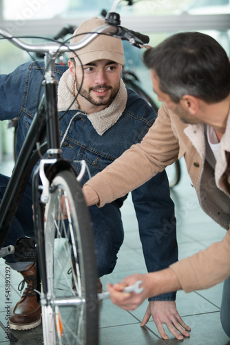 bike mechanic repairs a bicycle outdoors