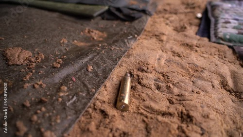 Wallpaper Mural a close-up of used shell casings being collected from the ground Torontodigital.ca