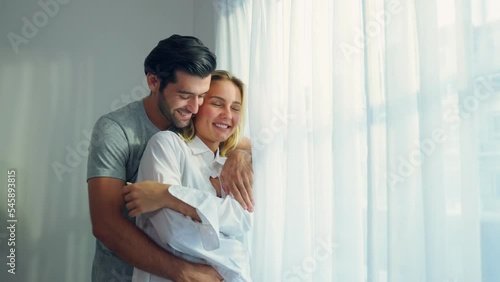 Caucasian young couple spend free leisure time together in living room photo