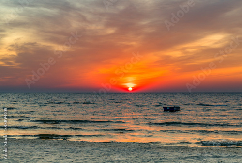 Sunset on sandy beach of the Baltic Sea