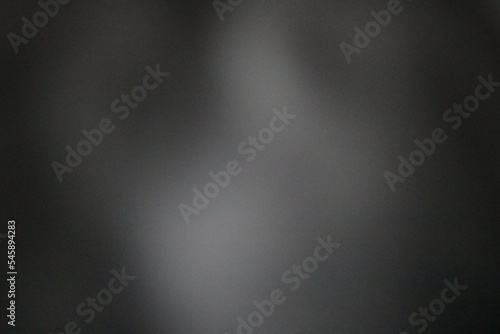 Blurred soft grey coloured mottled background with space for copy