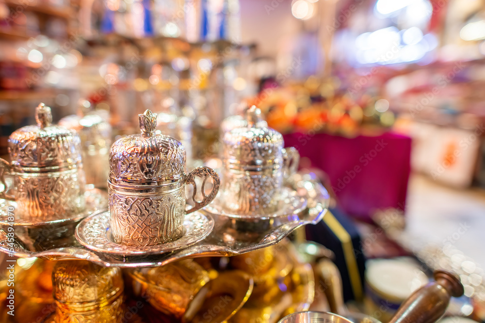 Silver tea cups in arabic style in a street market at night Silver tea cups in arabic style in a street market at night