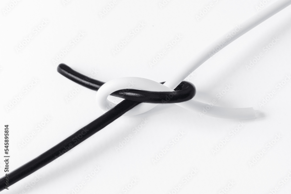 black and white cord tied in a knot in a symbol of tolerance black and white cord tied in a knot in a symbol of tolerance