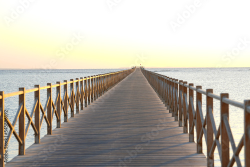 Golden sea sunset on the wooden pier.