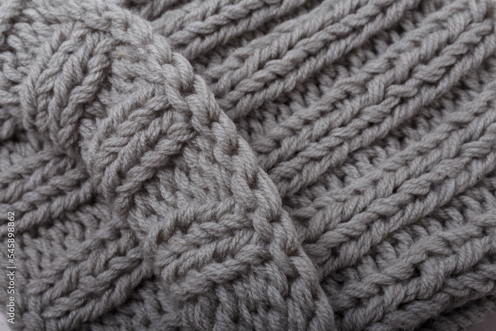 Knit grey fabric texture, background or backdrop. Textile, scarf or sweater textured surface. Warm accessories, clothing, fashion concept. Knit grey fabric texture, background or backdrop. Textile, scarf or sweater textured surface. Warm accessories, clothing, fashion concept.