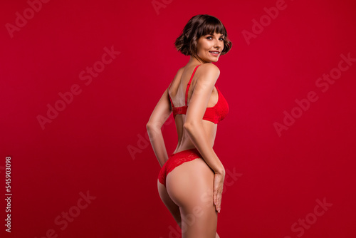 Profile side view portrait of attractive chic nude brown-haired girl posing perfect shape isolated over bright red color background