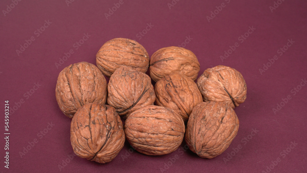 Closeup photo of a walnut seed in wooden bowl. Food that is good for brain and lower risk of heart disease. Closeup photo of a walnut seed in wooden bowl. Food that is good for brain and lower risk of heart disease.