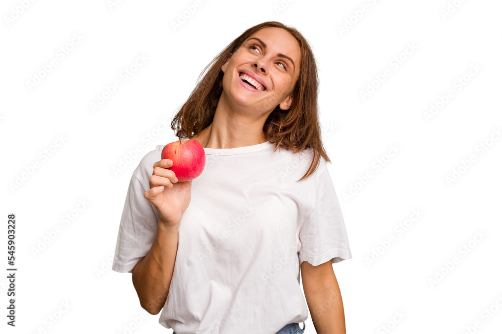 Young caucasian woman holding a red apple isolated dreaming of achieving goals and purposes Young caucasian woman holding a red apple isolated dreaming of achieving goals and purposes