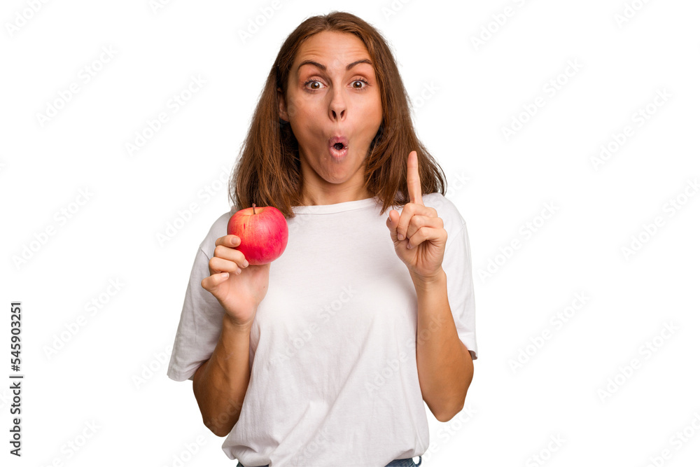 Young caucasian woman holding a red apple isolated having some great idea, concept of creativity.