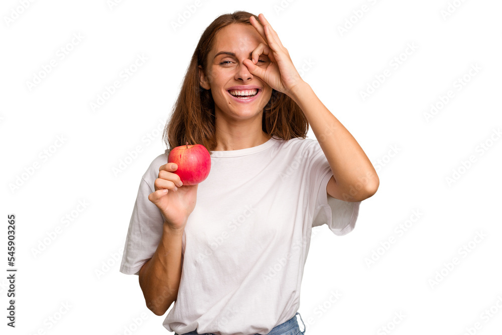 Young caucasian woman holding a red apple isolated excited keeping ok gesture on eye. Young caucasian woman holding a red apple isolated excited keeping ok gesture on eye.