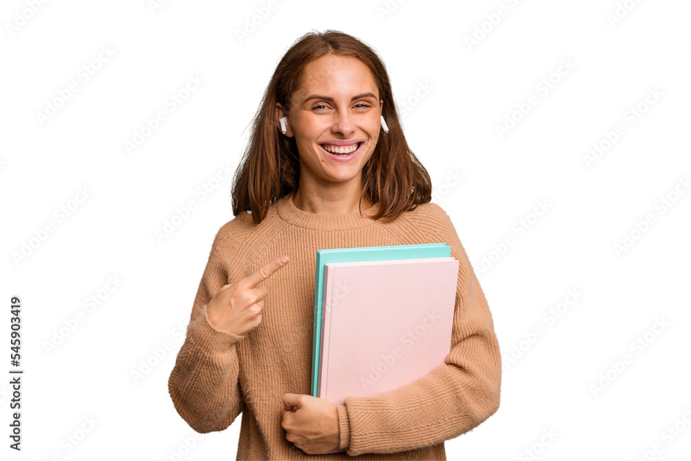 Young student woman holding a books isolated smiling and pointing aside, showing something at blank space. Young student woman holding a books isolated smiling and pointing aside, showing something at blank space.