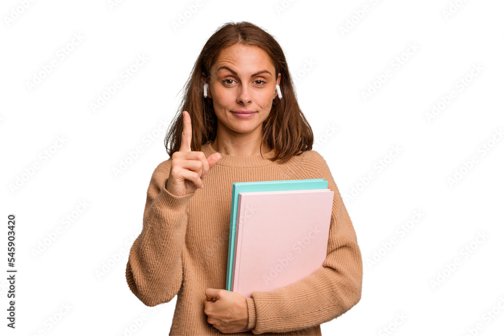Young student woman holding a books isolated showing number one with finger. Young student woman holding a books isolated showing number one with finger.