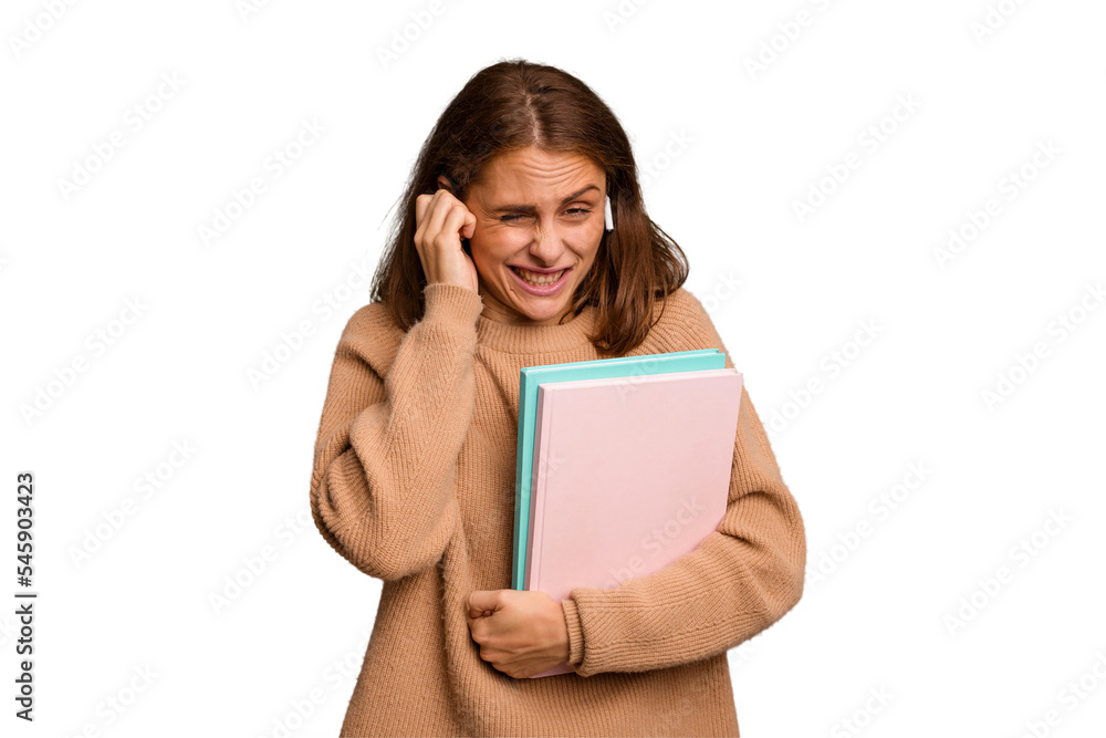 Young student woman holding a books isolated covering ears with hands. Young student woman holding a books isolated covering ears with hands.