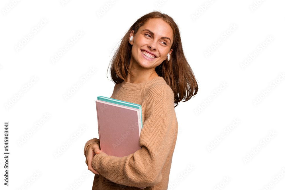 Young student woman holding a books isolated looks aside smiling, cheerful and pleasant. Young student woman holding a books isolated looks aside smiling, cheerful and pleasant.