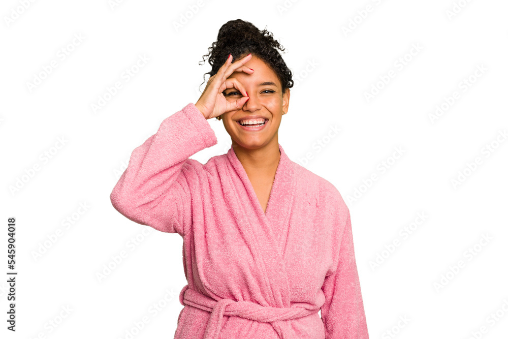 Young brazilian woman wearing a pink bathrobe isolated excited keeping ok gesture on eye. Young brazilian woman wearing a pink bathrobe isolated excited keeping ok gesture on eye.