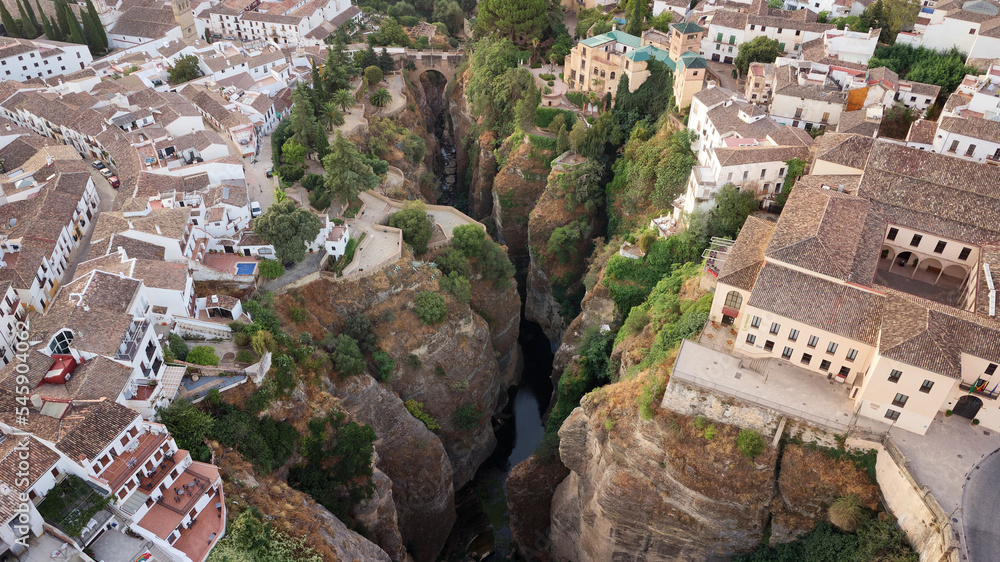 Aerial drone view of Ronda village. White villages in the province of Malaga, Andalusia, Spain. Beautiful village on the cliff of the mountain. Touristic destination. Holidays and enjoy the sun. 
