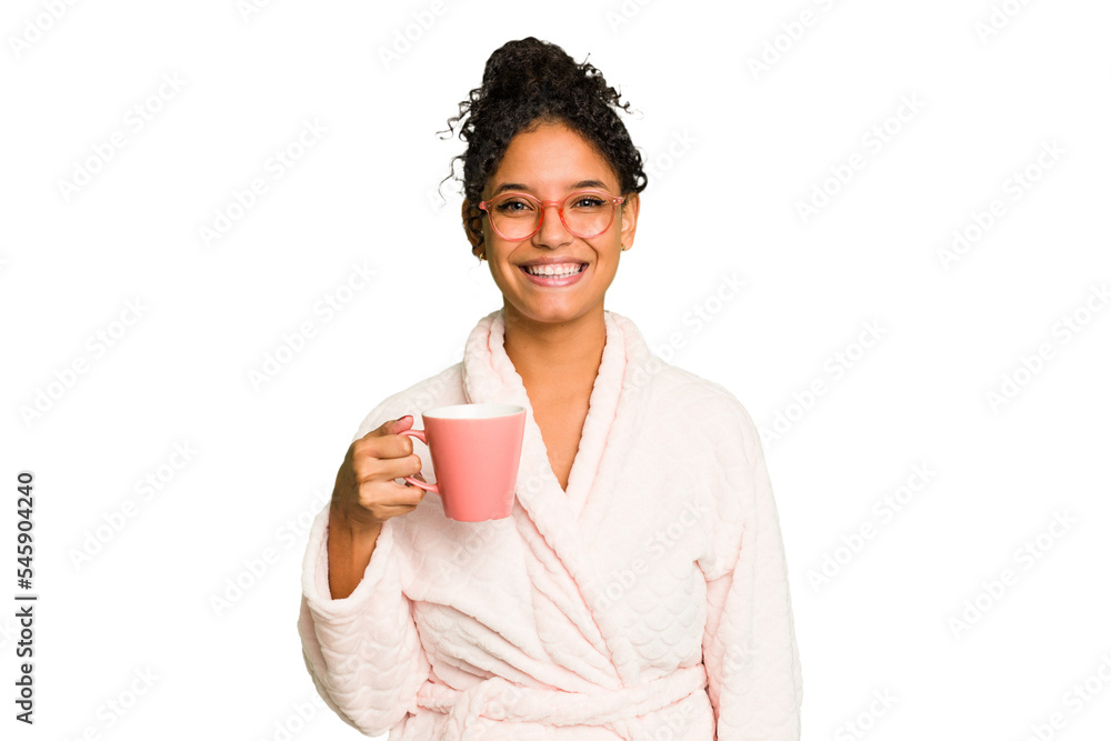 Young brazilian woman wearing a pajama holding a cup isolated happy, smiling and cheerful. Young brazilian woman wearing a pajama holding a cup isolated happy, smiling and cheerful.
