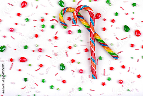 Christmas background of colorful candies, cane lollipops on a white background, close-up