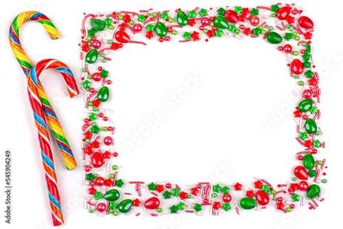 Frame of Christmas colorful candies, cane lollipops, on a white background, close-up, copy space