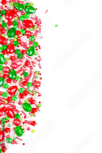 Christmas background of colorful candies. Red and green candies of different shapes on a white background, close-up. copy space.
