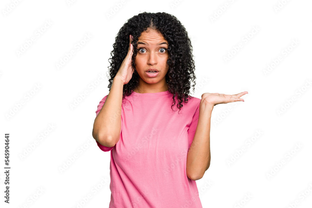 Young cute brazilian woman isolated impressed holding copy space on palm. Young cute brazilian woman isolated impressed holding copy space on palm.