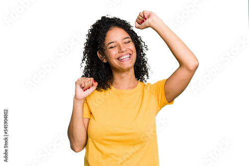 Young cute brazilian woman isolated celebrating a special day, jumps and raise arms with energy.