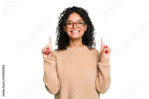 Young cute brazilian woman isolated indicates with both fore fingers up showing a blank space.