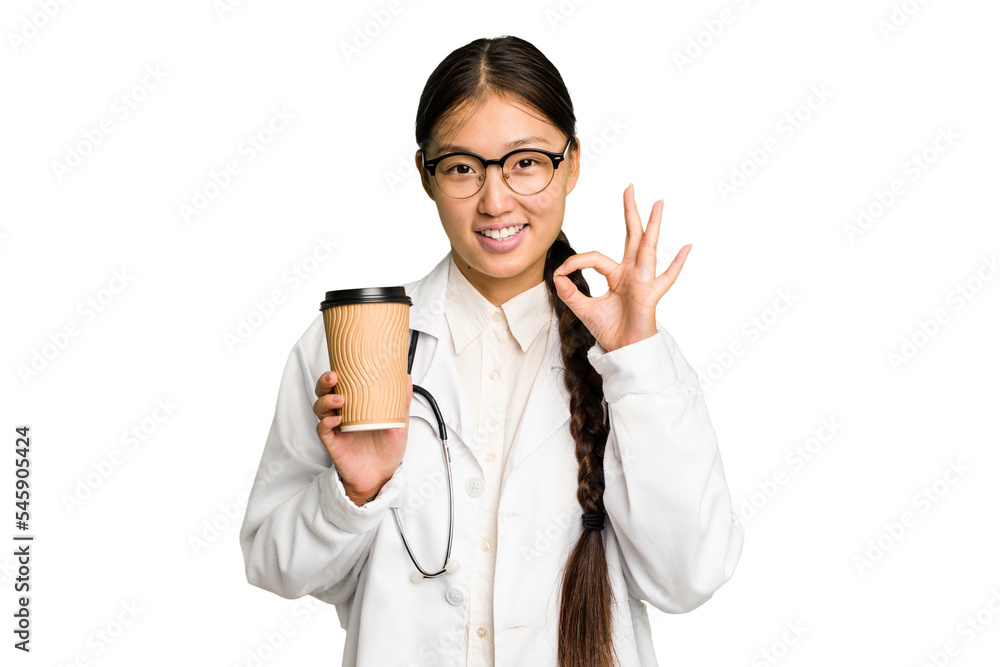 Young doctor asian woman holding a takeaway coffee isolated cheerful and confident showing ok gesture. Young doctor asian woman holding a takeaway coffee isolated cheerful and confident showing ok gesture.