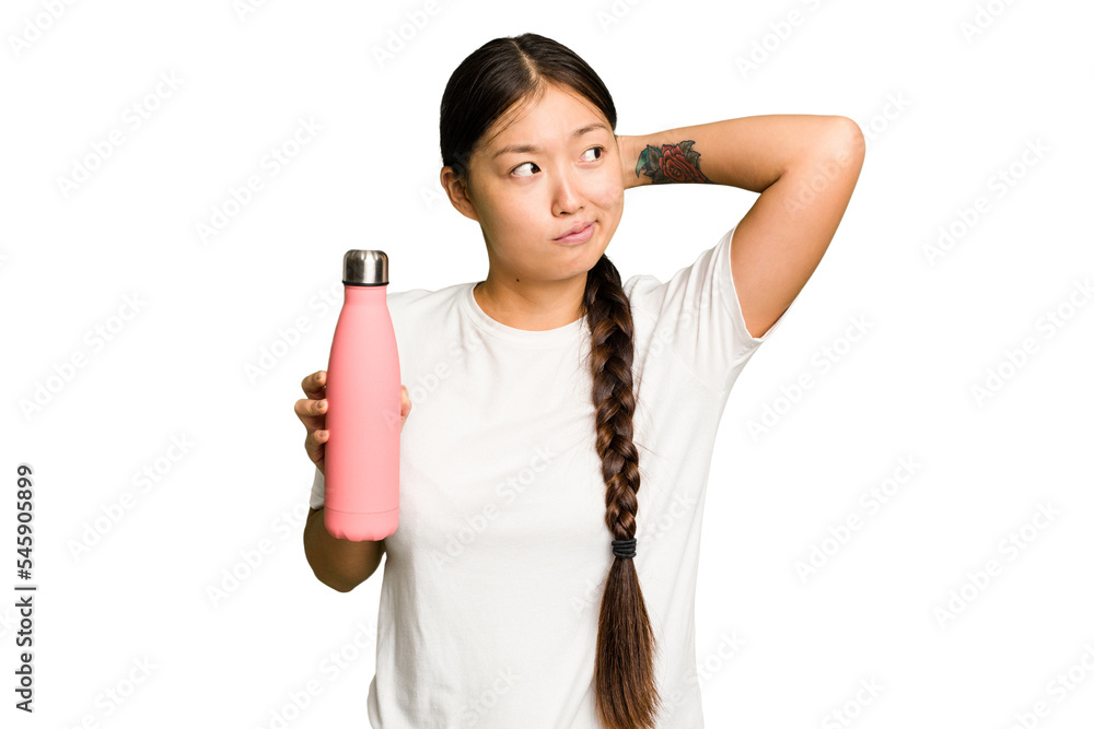 Young asian woman holding a pink thermo isolated touching back of head, thinking and making a choice.
