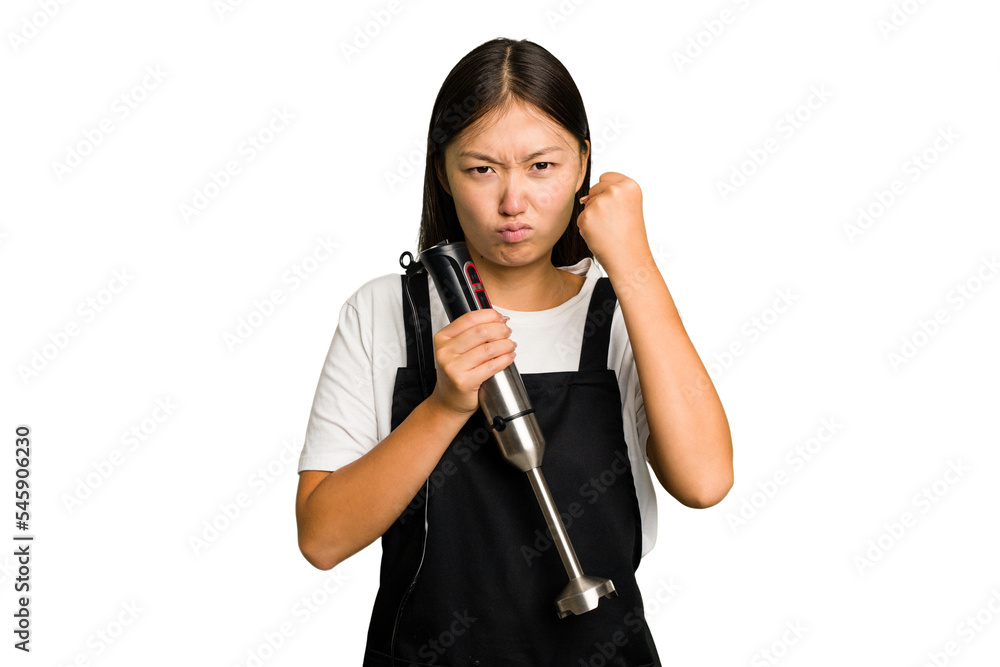 Young asian cook woman holding a blender isolated showing fist to camera, aggressive facial expression.