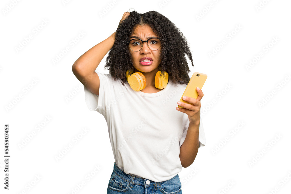 Young african american woman listening to music with yellow headphones isolated being shocked, she has remembered important meeting. - obrazy, fototapety, plakaty 