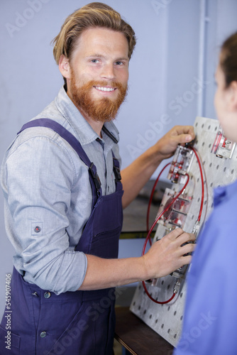 close-up of a young smiling man working with cables © auremar