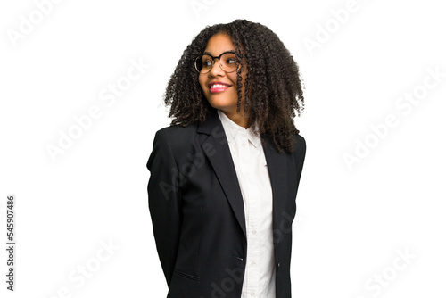 Young african american business woman isolated looks aside smiling, cheerful and pleasant.