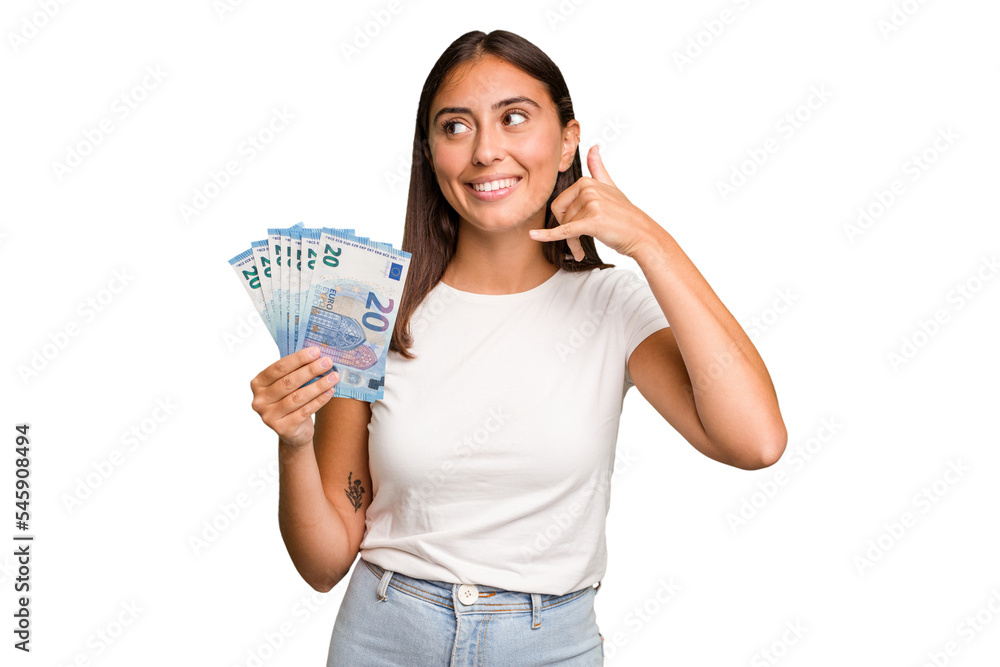 Young caucasian woman holding a banknotes isolated showing a mobile phone call gesture with fingers. Young caucasian woman holding a banknotes isolated showing a mobile phone call gesture with fingers.