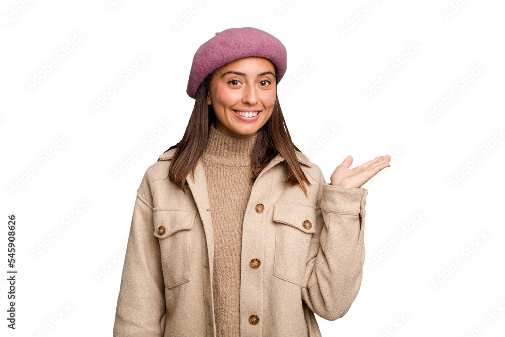 Young caucasian woman wearing winter jacket isolated showing a copy space on a palm and holding another hand on waist. Young caucasian woman wearing winter jacket isolated showing a copy space on a palm and holding another hand on waist.